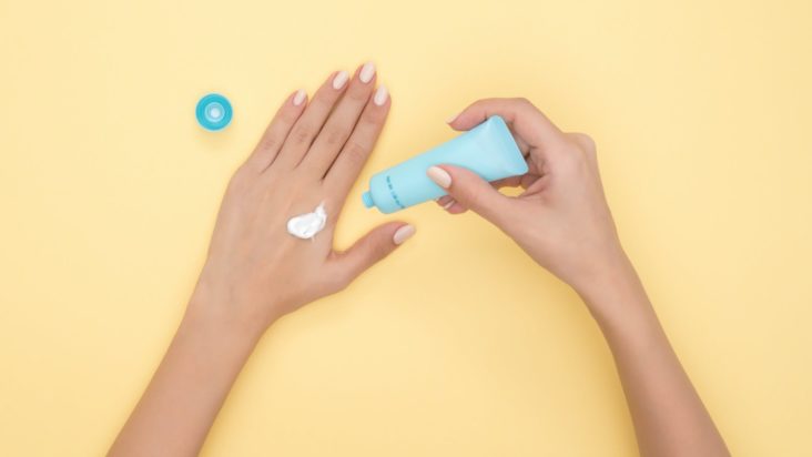 Woman tests cream on her hand