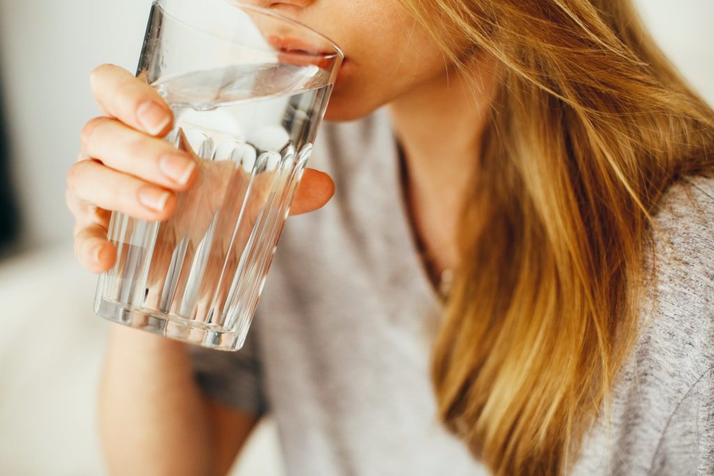 A photo of a woman drinking water
