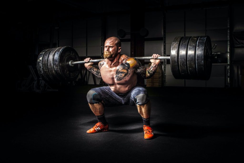 A photo of a man lifting weights