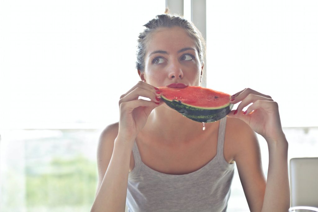 A photo of a woman eating a snack